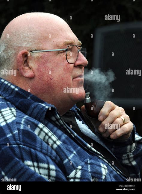 Old Man Smoking A Pipe In His Back Garden Stock Photo Alamy