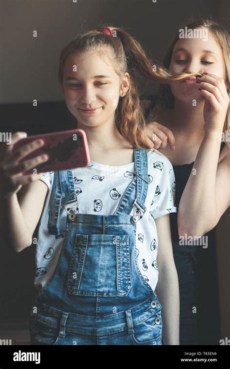 Young Women Taking Selfie Using Smartphone Camera Girls Making Faces Enjoying Taking Funny