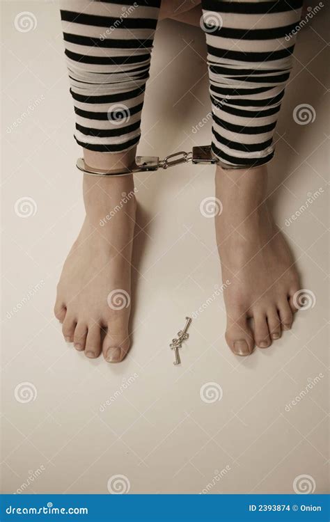A Depressed Man In Handcuffs Behind Bars A Depressed Arrested Male