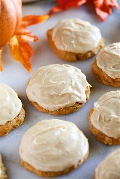 Pumpkin Cookies With Caramel Frosting On A White Marble Board With Fall