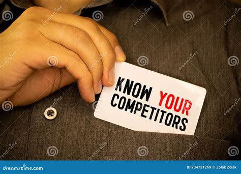 Businessman Putting A Card With Text Know Your Competitors In The