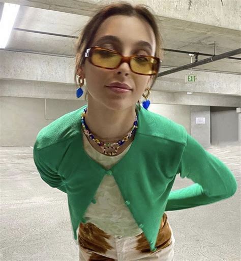 Emma Chamberlain In Green Patterned Shirt With Green Cardigan And Cow Print Pants In 2021