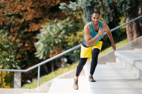 Good Looking Dark Skinned Athlete Exercising On The Stairs Stock Photo