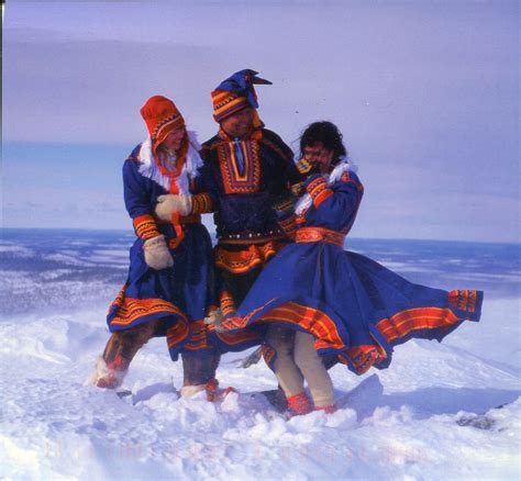 Saami People In Traditional Dress Laughing And Smiling In The Snow