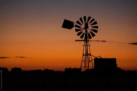 Old Farm Windmill At Sunset By Stocksy Contributor Rowena Naylor