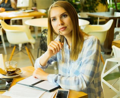 premium photo smart woman writing down her ideas and drinking coffe in cafe