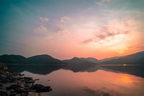 Panorama Scenic Of Mountain Lake With Perfect Reflection At Sunset