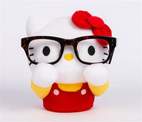 a hello kitty doll with glasses and a red bow on it s head is shown in front of a white background