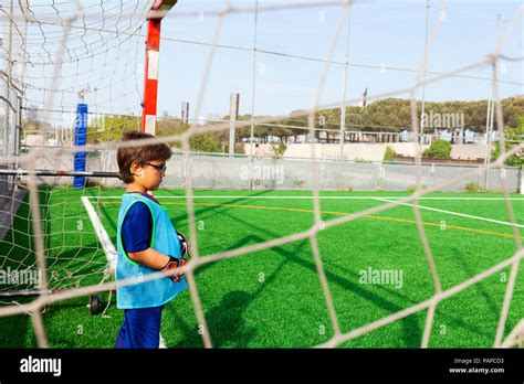 Little Boy Standing At Goal On Football Ground Stock Photo Alamy