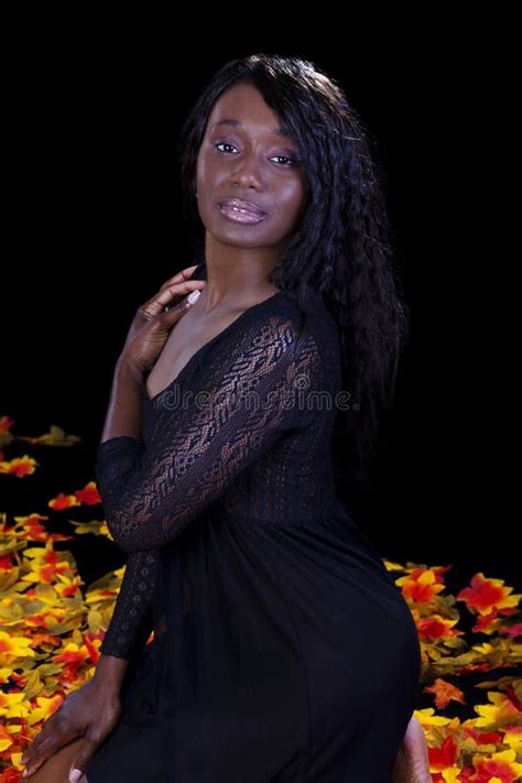 African American Woman Kneeling Lingerie Autumn Leaves Stock Photo