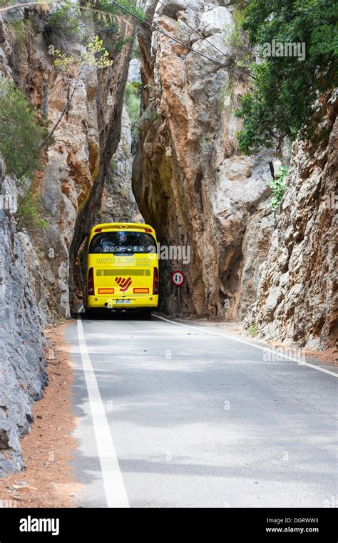 Bus Driving Through A Narrow Tunnel Along The Winding Mountain Road To