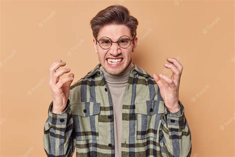 Premium Photo Irritated Young Man Gestures Angrily Clenches Teeth