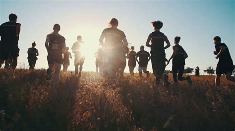 Group Of People Running On Field In Sunset Stock Footage Sbv