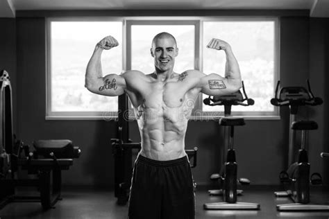 Muscular Man Flexing Muscles In Gym Stock Photo Image Of Lifestyle