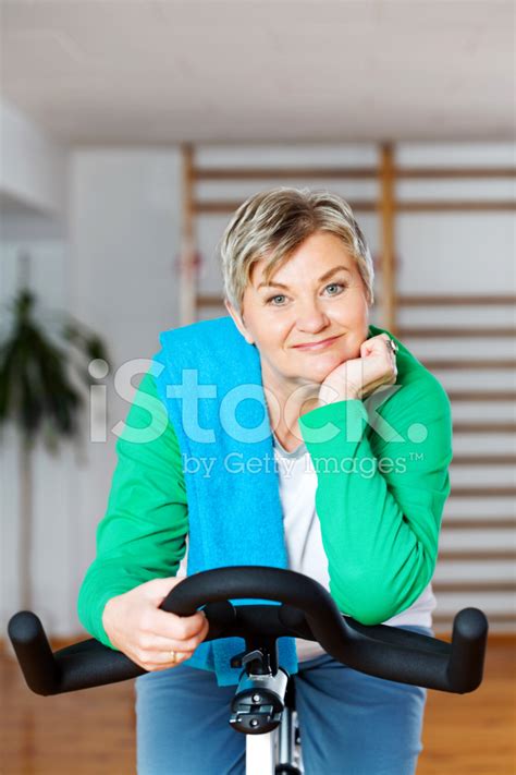 Active Mature Woman Cycling At The Gym Stock Photo Royalty Free Freeimages