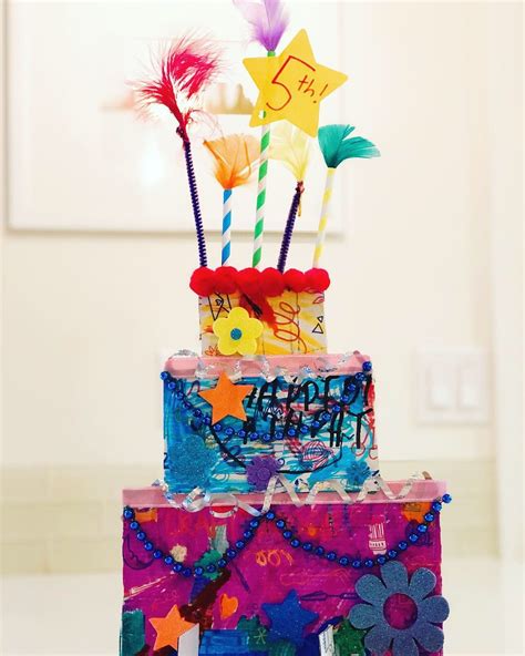 A Three Tiered Birthday Cake With Colorful Decorations