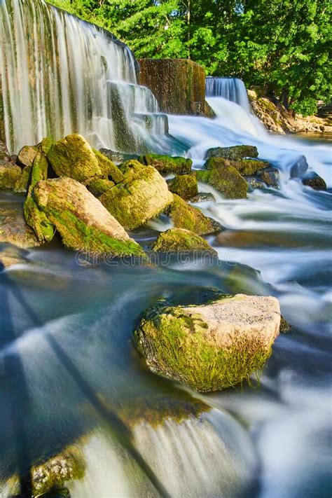 Algae Rocks Next To Manmade Waterfalls And Smooth Water Stock Image