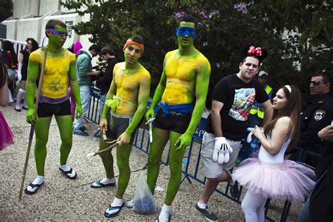 People In Costumes Take Part In A Street Party For The Jewish Holiday