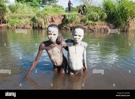 Two Surma Babes With Body Paintings In The River Kibish Omo River Valley Ethiopia Stock Photo