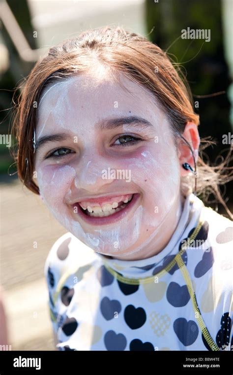 A Happy Smiling Young Pre Teen Girl With High Factor Sun Block White