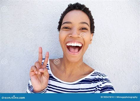 Close Up Black Woman Laughing And Holding Peace Hand Sign Stock Photo
