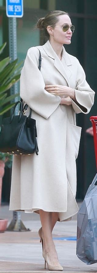 Who Made Angelina Jolies Tan Coat And Aviator Sunglasses