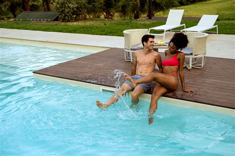 Interracial Couple Play Splash Water Sitting Poolside Multiracial