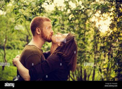 Caucasian Couple Hugging Near Trees Stock Photo Alamy