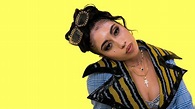 Kali Uchis Is Wearing Colorful Dress Standing In Yellow Wall Background ...