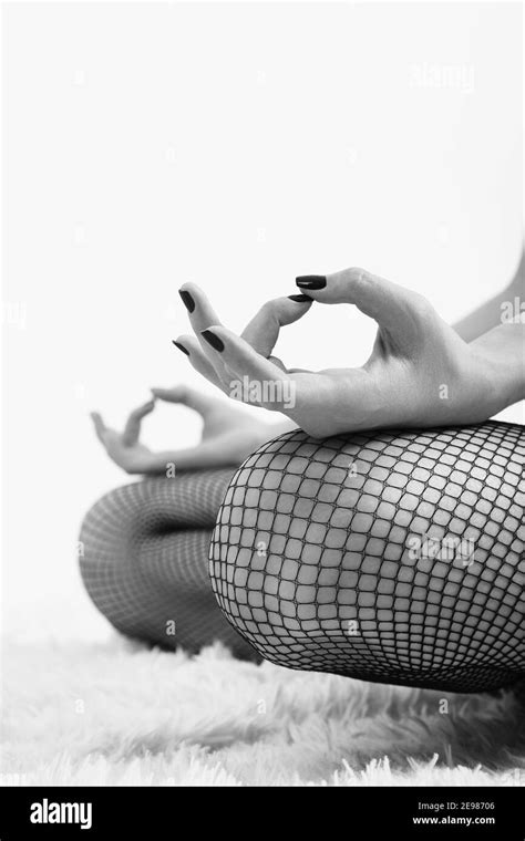 Female Hands In Yoga Mudra Gesture On Knees White Background Feet In