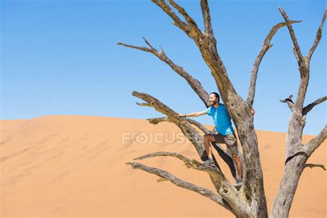 Namibia Namib Desert Man Sitting On Dead Tree In Deadvlei — Landscape