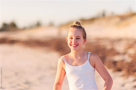 Smiling Pre Teen Girl At The Beach At Sunset By Angela Lumsden Beach