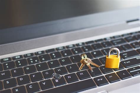 Golden Locked Padlock And Keys On Laptop Keyboard Stock Photo