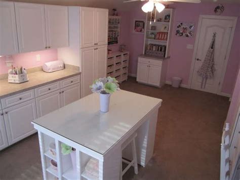 Craft room transformation including a crafting island! Craft room with white cabinets, work island and pink walls ...