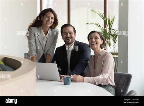 Three Diverse Office Employees Posing Smile Staring At Camera Stock