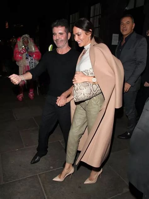 simon cowell and fiancée lauren look smitten as she flashes £250k