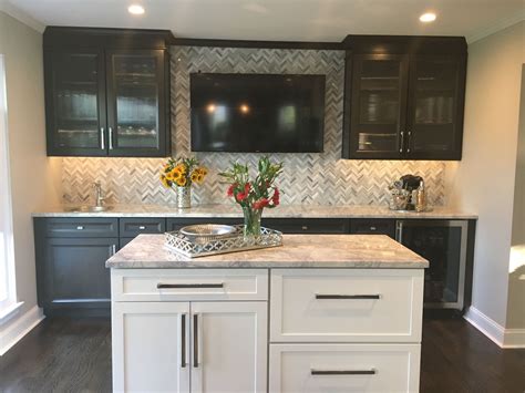 Wet Bar With Dark Cabinets Gray And White Herringbone Backsplash And