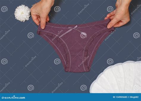 women`s hands with beautiful panties and sanitary pads on gray background stock image image of