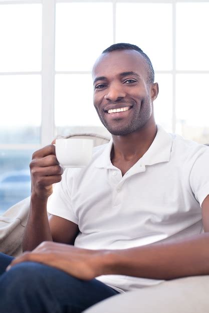 Premium Photo Man Drinking Coffee Cheerful African Man Drinking Coffee And Smiling
