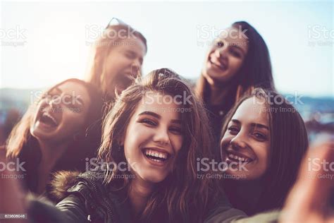 Group Of Smiling Girls Taking A Selfie Outdoors At Sunset Zdjęcia