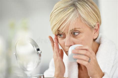 Senior Woman Applying Anti Aging Cream On Her Skin Stock Image Image