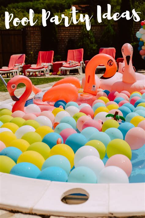 An Inflatable Pool Filled With Flamingos And Balloons