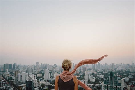 Woman Looking The Cityscape From The Roof By Stocksy Contributor