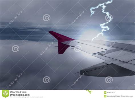Lightening Strikes Aircraft Wing Of Airplane On Dark Sky Stock Image