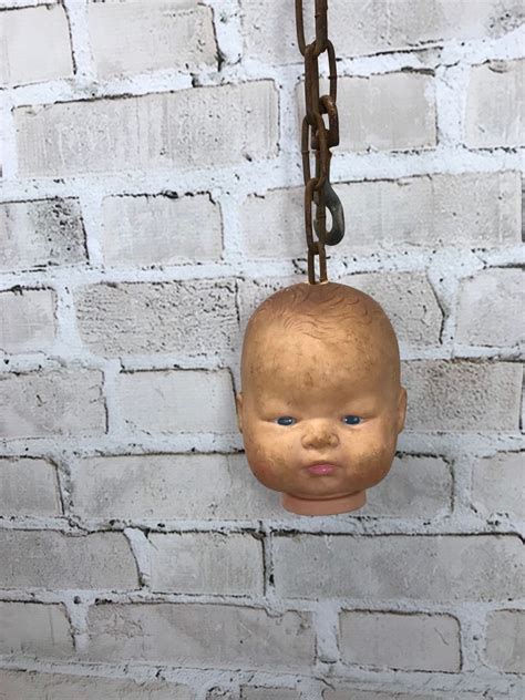 Creepy Doll Head Hanging From A Chain Halloween Display Etsy Scary Dolls Halloween Displays