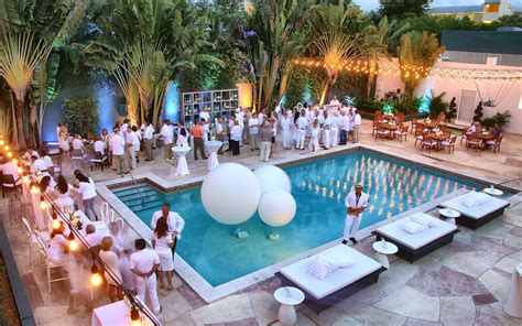 An Aerial View Of A Pool With White Balloons And People Standing Around