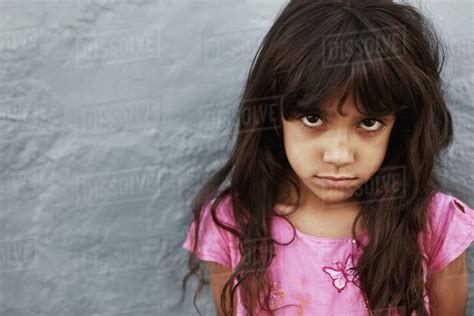 Close Up Portrait Of Preteen Girl With Serious Expression Standing