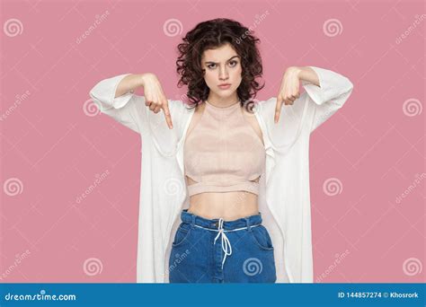 Here And Right Now Portrait Of Serious Cute Brunette Young Woman With Curly Hairstyle In Casual