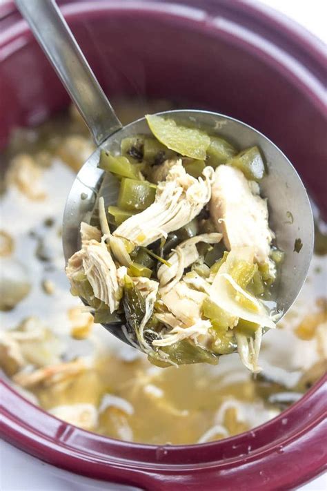 A Spoon Full Of Soup With Chicken And Green Beans In The Bowl On The Table