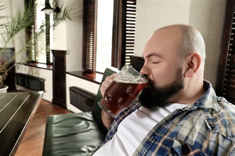Premium Photo Bearded Man Drinking Beer In Pub